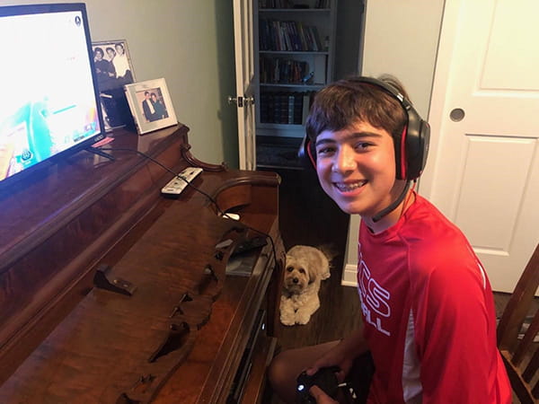 Cole using the family piano as a video game shelf