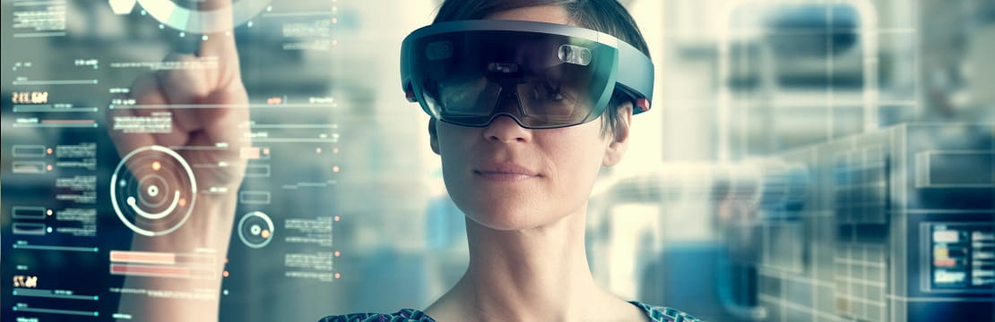 Woman points at an augmented reality screen while wearing compatible eyewear